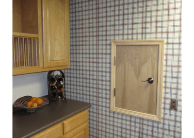 A kitchen with a wooden cabinet and a window.