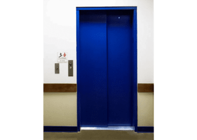 A blue door in the middle of a room.