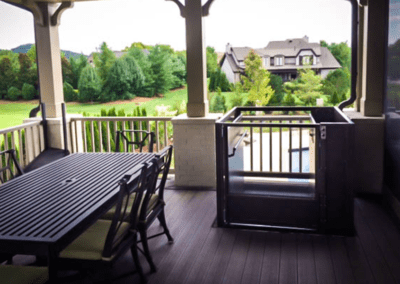 A table and chairs on the porch of a house.