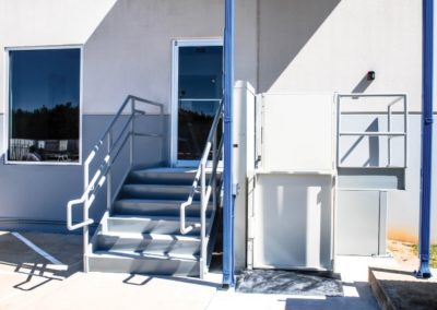 A building with stairs and steps leading to the door.