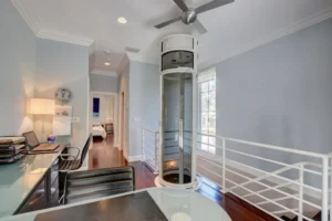 Modern home interior featuring a residential glass elevator and sleek design.