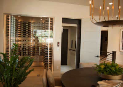 A room with a table and chairs, wine cellar.