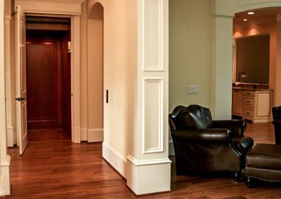 A chair and a couch in the corner of a room.