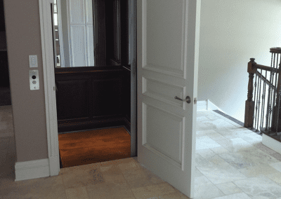 A door open to the living room with a view of the hallway.